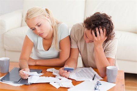 Unhappy couple listing expenses in the living room Stock Photo - Budget Royalty-Free & Subscription, Code: 400-04904943