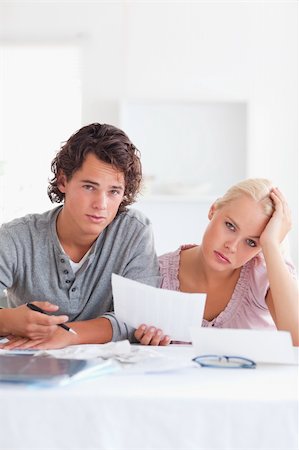 Unhappy couple reading a letter in the living room Stock Photo - Budget Royalty-Free & Subscription, Code: 400-04904955