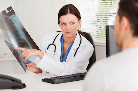 patient talking to office worker - A female doctor is showing her patient an x-ray Stock Photo - Budget Royalty-Free & Subscription, Code: 400-04905085