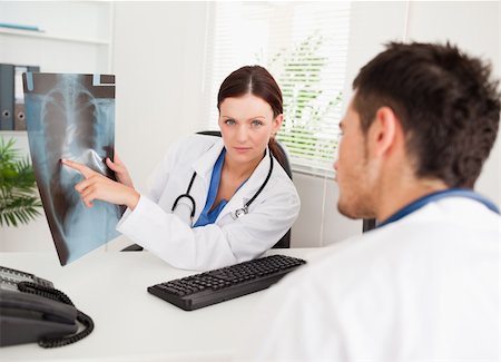 patient talking to office worker - A female doctor is showing a x-ray to another doctor in her office Stock Photo - Budget Royalty-Free & Subscription, Code: 400-04905088