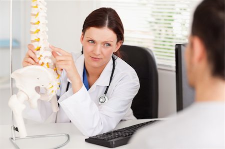 patient talking to office worker - A female doctor is showing a doctor something on a spine Stock Photo - Budget Royalty-Free & Subscription, Code: 400-04905103