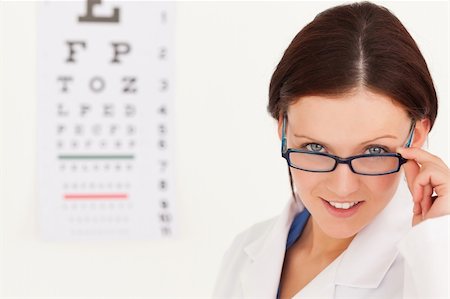 simsearch:400-07630065,k - A female optician with glasses and eye test in her office Foto de stock - Super Valor sin royalties y Suscripción, Código: 400-04905151