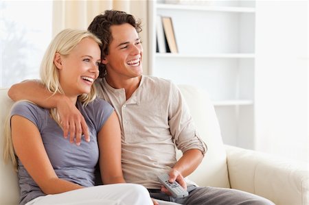 elegant tv room - Laughing couple watching TV in their living room Foto de stock - Super Valor sin royalties y Suscripción, Código: 400-04905559