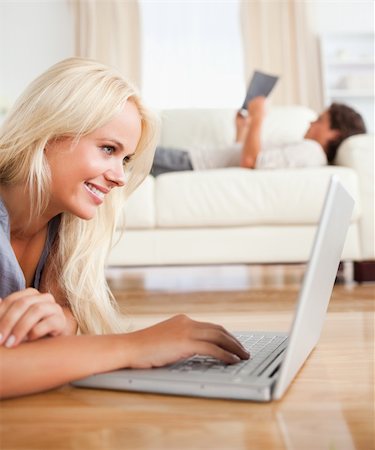 floor heat - Portrait of a woman using a laptop while her husband is reading in their living room Stock Photo - Budget Royalty-Free & Subscription, Code: 400-04905694