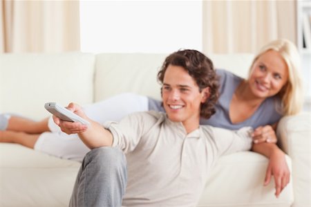 elegant tv room - Smiling young couple watching TV in their living room Stock Photo - Budget Royalty-Free & Subscription, Code: 400-04905704