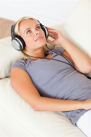 simsearch:400-04418454,k - Portrait of a gorgeous woman enjoying some music in her living room Foto de stock - Royalty-Free Super Valor e Assinatura, Número: 400-04905826