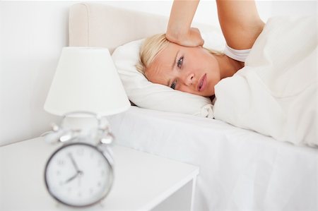 simsearch:6109-06194890,k - Woman awaken by her alarn clock in her bedroom Stockbilder - Microstock & Abonnement, Bildnummer: 400-04906014