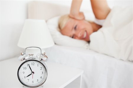 simsearch:6109-06194402,k - Angry woman awaken by her alarnclock in her bedroom Stock Photo - Budget Royalty-Free & Subscription, Code: 400-04906015