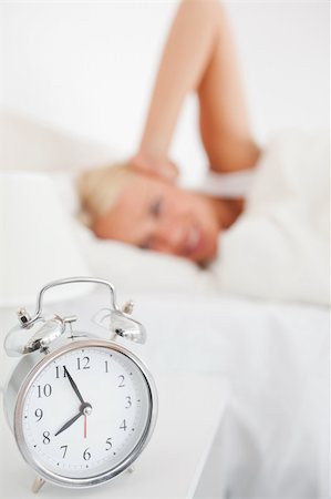 simsearch:6109-06194402,k - Alarmclock waking up a woman with the camera focus on the object Stock Photo - Budget Royalty-Free & Subscription, Code: 400-04906011