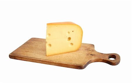 Big piece of cheese on wooden cutting board. Isolated on white with clipping path Foto de stock - Super Valor sin royalties y Suscripción, Código: 400-04906300