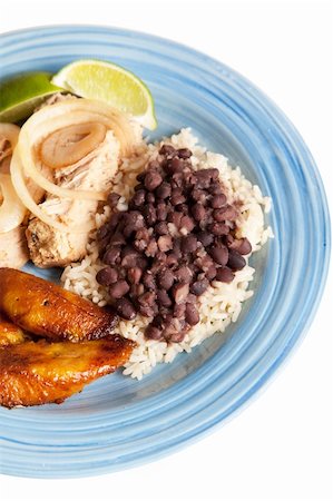 Traditional Cuban meal, of roast pork, black beans and rice, and sweet fried plantains.  Isolated on white with clipping path. Stock Photo - Budget Royalty-Free & Subscription, Code: 400-04907414