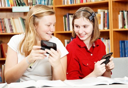 students reading book in classroom teen - Two teenage girls texting in school, instead of studying. Stock Photo - Budget Royalty-Free & Subscription, Code: 400-04907416