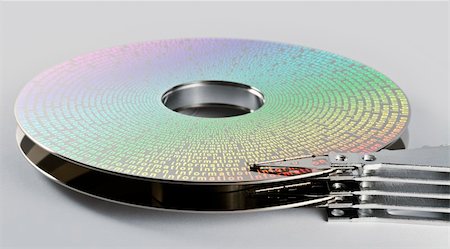 festplatte - parts of hard disk drive in grey background with symbolized information on magnetic surface Stockbilder - Microstock & Abonnement, Bildnummer: 400-04907933