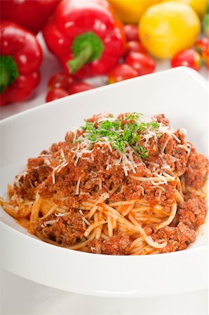 Italian classic  spaghetti with bolognese sauce and fresh vegetables on background,MORE DELICIOUS  FOOD ON PORTFOLIO Stock Photo - Budget Royalty-Free & Subscription, Code: 400-04908247