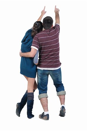 Young couple looks where that. Rear view. Isolated over white. Stock Photo - Budget Royalty-Free & Subscription, Code: 400-04908301