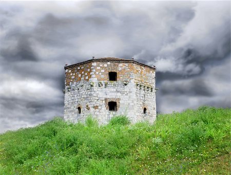 Old tower of Belgrade fortress on green hill over storming sky Stockbilder - Microstock & Abonnement, Bildnummer: 400-04908421