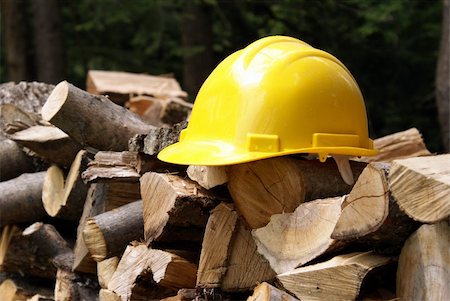 simsearch:400-04909076,k - It's better safe than sorry when your in the forest cutting trees down, thus the hard hat on the woodpile. Stock Photo - Budget Royalty-Free & Subscription, Code: 400-04909076