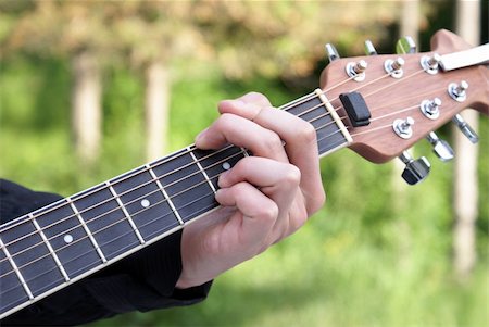 simsearch:400-05080507,k - A closeup shot of a young man playing his guitar. Stock Photo - Budget Royalty-Free & Subscription, Code: 400-04909073