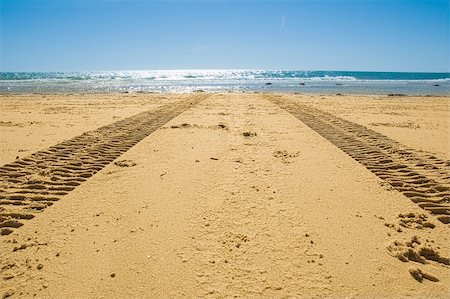 road line marking - tractor tracks on the golden sand leading into the sea Stock Photo - Budget Royalty-Free & Subscription, Code: 400-04909218
