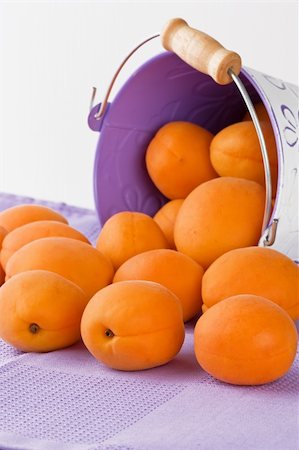 simsearch:400-05705062,k - Ripe fresh apricot spilling out of a pail shallow DOF Photographie de stock - Aubaine LD & Abonnement, Code: 400-04909344