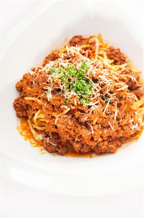 Italian classic  spaghetti with bolognese sauce and fresh vegetables on background,MORE DELICIOUS  FOOD ON PORTFOLIO Stock Photo - Budget Royalty-Free & Subscription, Code: 400-04909611