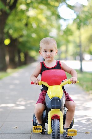 small babies in park - happy children in park ride cycle at park on summer season Stock Photo - Budget Royalty-Free & Subscription, Code: 400-04900034