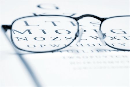 eye doctor test - An eye chart with a pair of glasses and selective focus within the frames to emphasize vision correction. Stock Photo - Budget Royalty-Free & Subscription, Code: 400-04900249