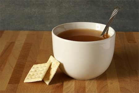 soup and crackers - A bowl of soup and some soda crackers leaning on it. Stock Photo - Budget Royalty-Free & Subscription, Code: 400-04900242