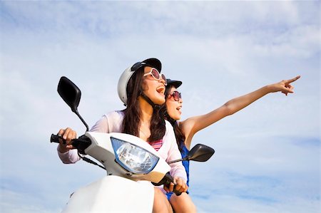 driving scooter women - happy girls riding scooter enjoy summer vacation Stock Photo - Budget Royalty-Free & Subscription, Code: 400-04900515