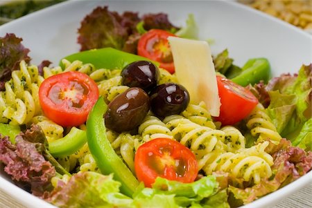 fresh healthy homemade italian fusilli pasta salad with parmesan cheese,pachino cherry tomatoes, black olives and mix vegetables ,dressed with extra-virgin olive oil and pesto sauce Stock Photo - Budget Royalty-Free & Subscription, Code: 400-04901013