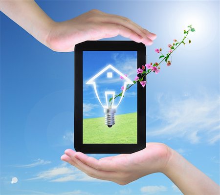 light bulb model of a house and pink flower on tablet PC in women hand Stock Photo - Budget Royalty-Free & Subscription, Code: 400-04901329