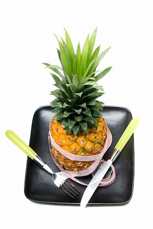 simsearch:400-04650758,k - pineapple on a black plate with tape meter,knife and fork isolated on white background Stock Photo - Budget Royalty-Free & Subscription, Code: 400-04901651