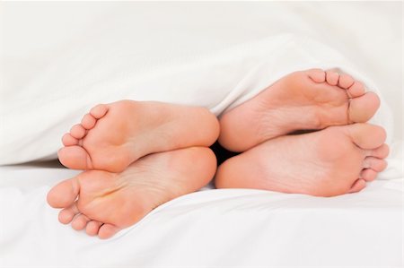 Two pair of feet in a bed Stock Photo - Budget Royalty-Free & Subscription, Code: 400-04903650