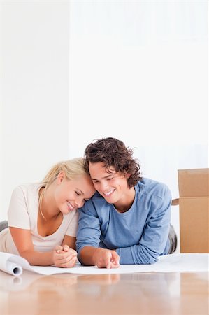 Portrait of an in love couple organizing their new home surrounded by boxes Stock Photo - Budget Royalty-Free & Subscription, Code: 400-04903947