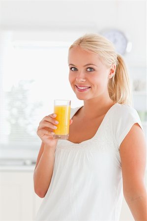 Woman drinking juice in her kitchen Stock Photo - Budget Royalty-Free & Subscription, Code: 400-04903985