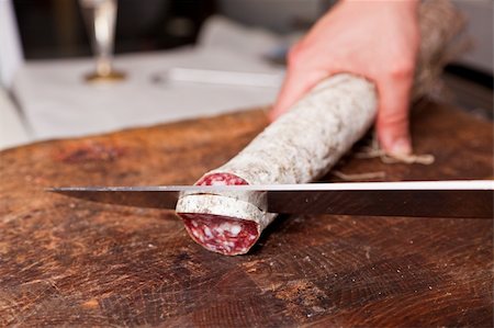 simsearch:400-05326789,k - Butcher Slicing Salami Fotografie stock - Microstock e Abbonamento, Codice: 400-04914010