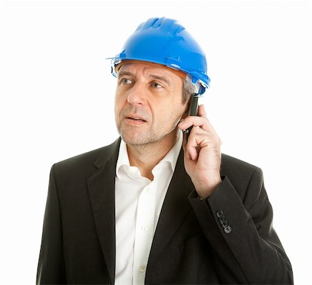 Portrait of architect wearing blue hard hat and talking on mobile phone. Isolated on white Photographie de stock - Aubaine LD & Abonnement, Code: 400-04915385