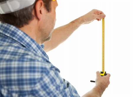 Confident worker using tape to measure dimensions. Isolated on white Fotografie stock - Microstock e Abbonamento, Codice: 400-04915430