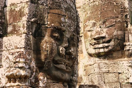 The Bayon is a Khmer temple at Angkor in Cambodia, built in the late 12th century or early 13th century as the official state temple of the Mahayana Buddhist King Jayavarman VII Following Jayavarman's death, it was modified and augmented by later Hindu and Theravada Buddhist kings in accordance with their own religious preferences.  The Bayon's most distinctive feature is the multitude of serene a Stock Photo - Budget Royalty-Free & Subscription, Code: 400-04915628