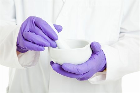 sfregare - Closeup of the hands of a pharmacist or scientist, holding a mortar and pestle, and wearing rubber gloves. Fotografie stock - Microstock e Abbonamento, Codice: 400-04915693