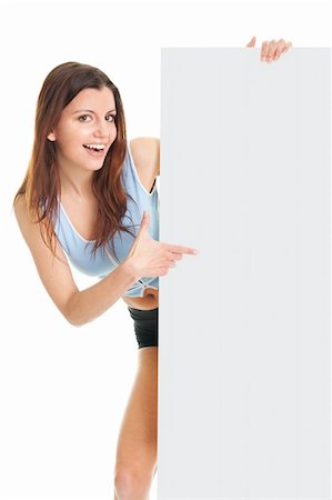 Fitness woman presenting empty placard. Isolated on white Fotografie stock - Microstock e Abbonamento, Codice: 400-04915808