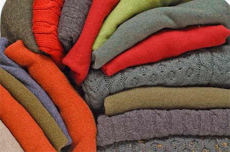 Fallen stack of chunky Irish wool cable knit, Cashmere and Aran winter men's sweaters in fall and winter colours against white Stock Photo - Budget Royalty-Free & Subscription, Code: 400-04915904