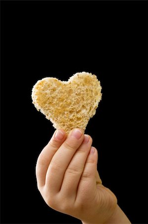 simsearch:400-05701644,k - A piece of bread offered with love - isolated on black Stock Photo - Budget Royalty-Free & Subscription, Code: 400-04916171
