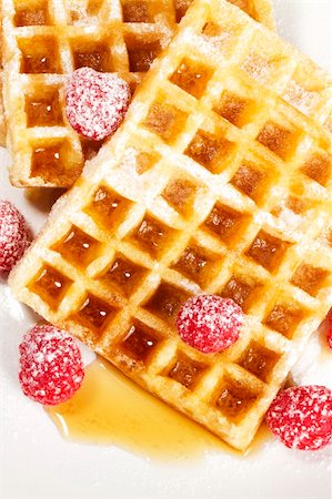 pancake bake - sugar covered raspberries on waffles with syrup from top on white background Stock Photo - Budget Royalty-Free & Subscription, Code: 400-04916955