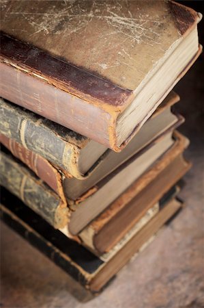 A Stack of old worn and tattered books. Short depth-of-field. Stock Photo - Budget Royalty-Free & Subscription, Code: 400-04917423