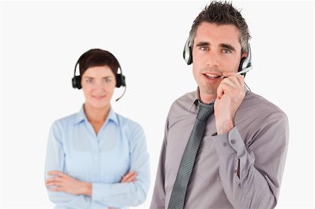 Isolated office workers using headsets against a white background Stock Photo - Budget Royalty-Free & Subscription, Code: 400-04917916