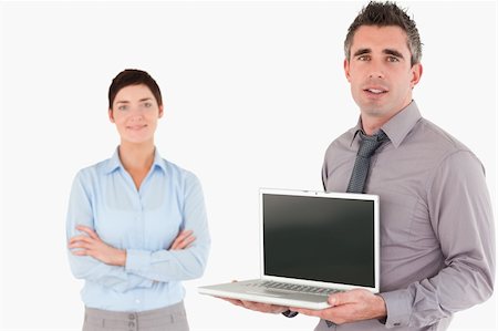 simsearch:400-04918393,k - Office worker showing a laptop while his colleague is posing against a white background Stock Photo - Budget Royalty-Free & Subscription, Code: 400-04917917
