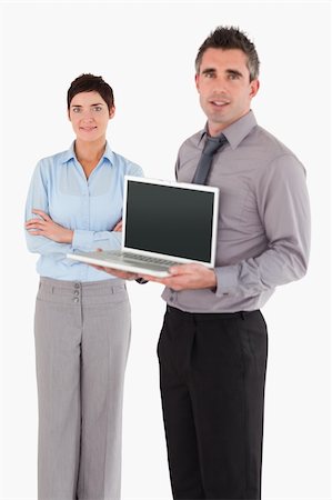 simsearch:400-04918393,k - Portrait of a man showing a notebook while his colleague is posing against a white background Stock Photo - Budget Royalty-Free & Subscription, Code: 400-04917919