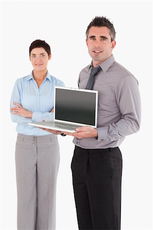 simsearch:400-04918393,k - Portrait of a man showing a laptop while his colleague is posing against a white background Stock Photo - Budget Royalty-Free & Subscription, Code: 400-04917920