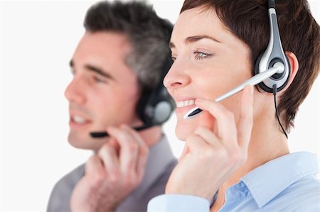 Close up of operators speaking through headsets against a white background Stock Photo - Budget Royalty-Free & Subscription, Code: 400-04917997